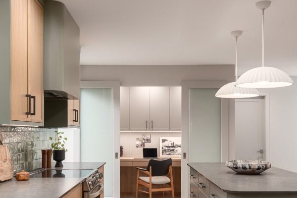 Modern kitchen renovation with adjacent home office, custom cabinetry, and warm wood finishes.